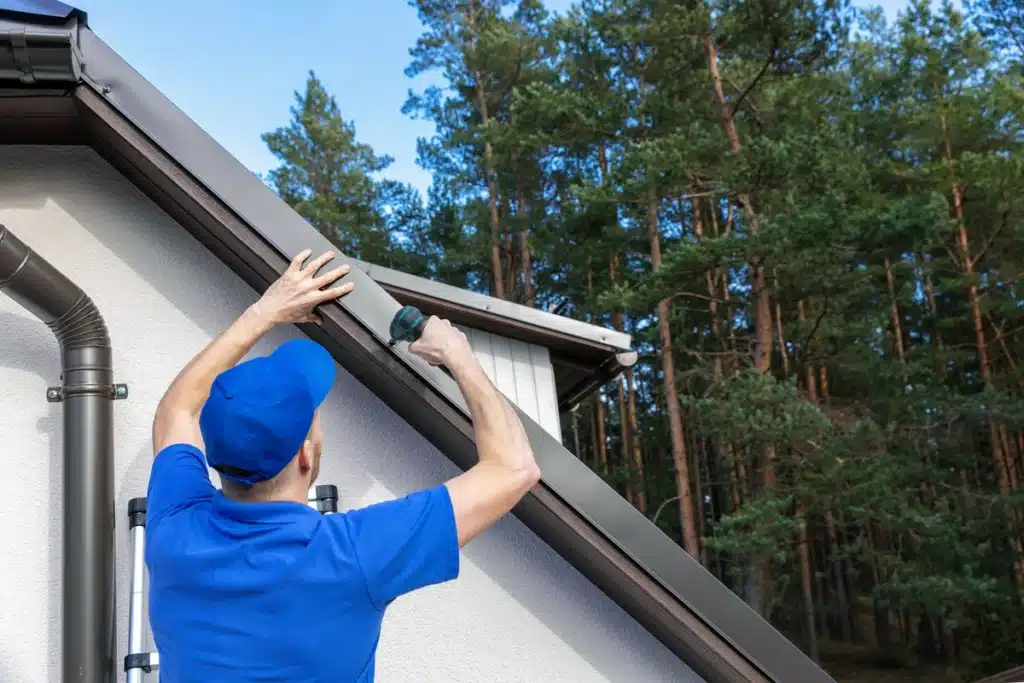 roofer installing a drip edge onto an edge 