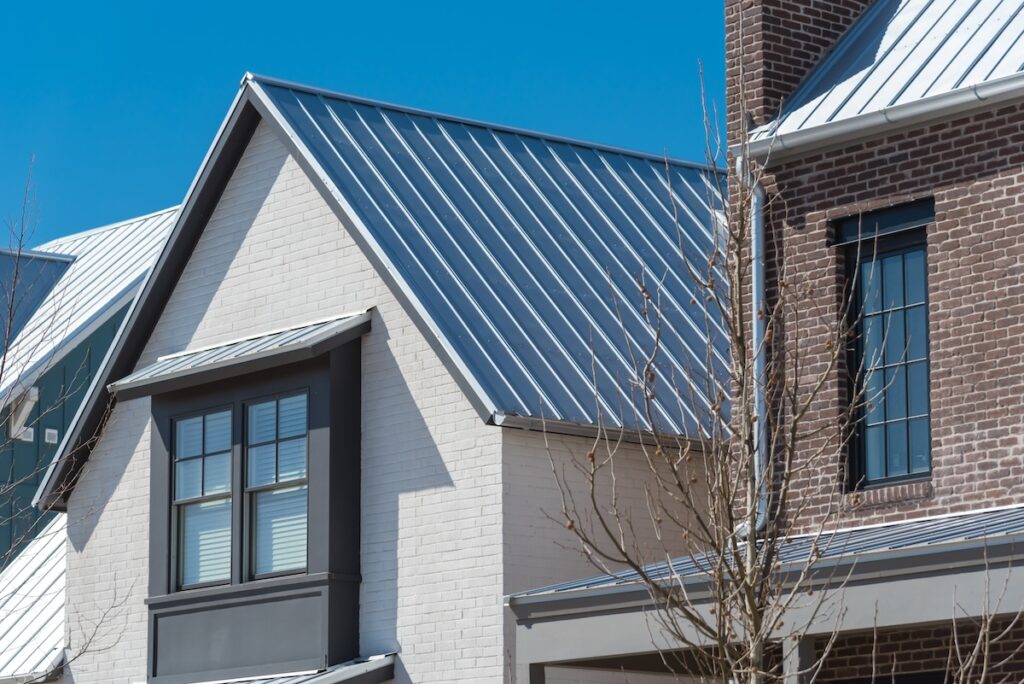 white residential house with metal seam roof