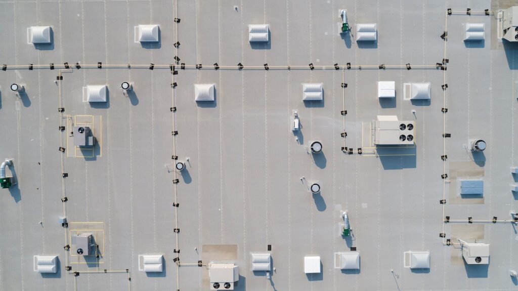 looking down on a commercial rooftop showing skylights and HVAC equipment