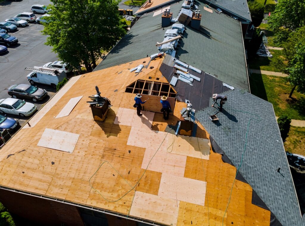 Construction workers renovating apartment roof