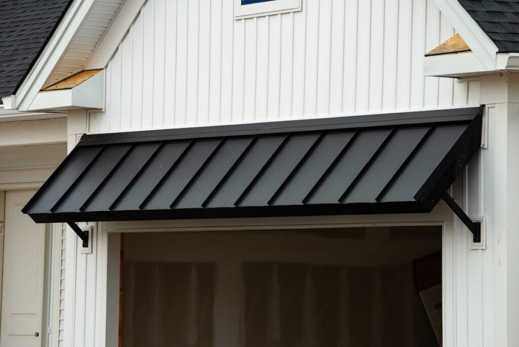 Black metal accent overhang on white house