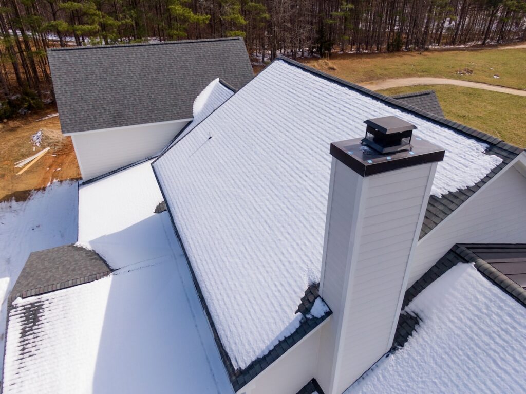 Metal chimney cap on newly built house
