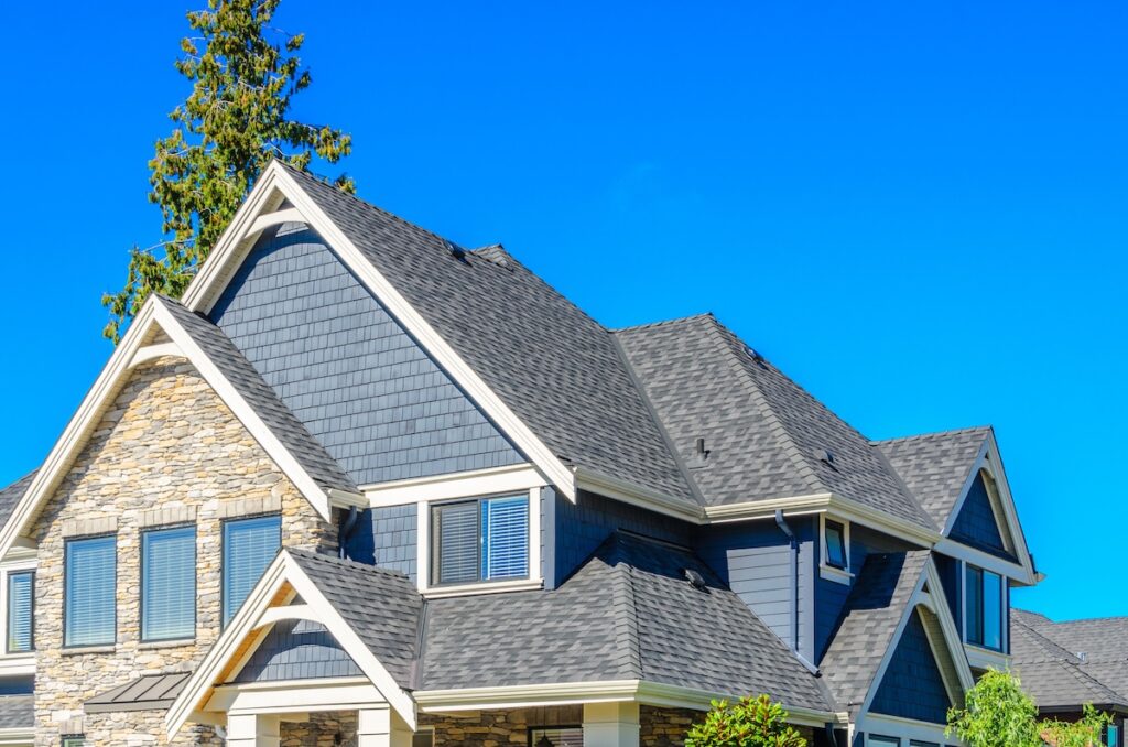 the roof of the house a newly installed asphalt roofing system