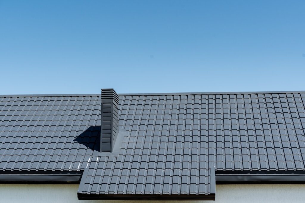 A building with a rectangular shape featuring a chimney on the roof, made of composite materials.