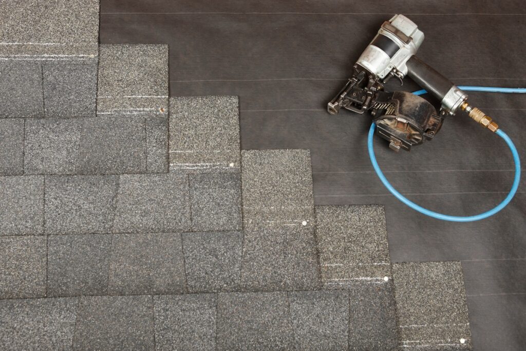 A new roof being applied, asphalt shingles