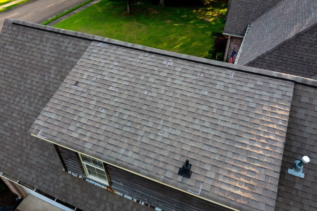Roof with hail damage and chalk markings from inspection
